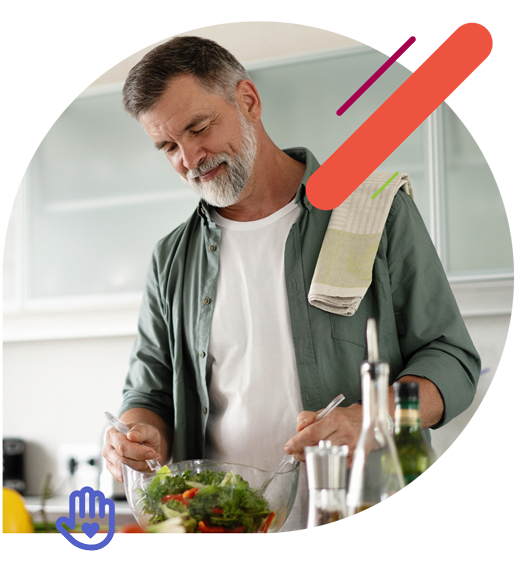 Man mixing a salad in the kitchen