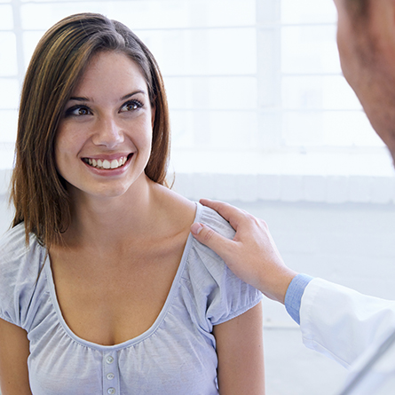Doctor with hand on patients' shoulder