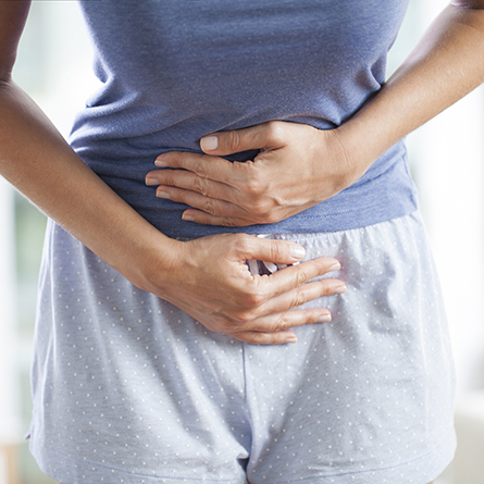 Woman holding her stomach in pain