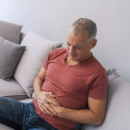 Man holding his stomach in pain