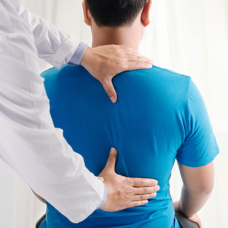 Doctor checking a patients' back