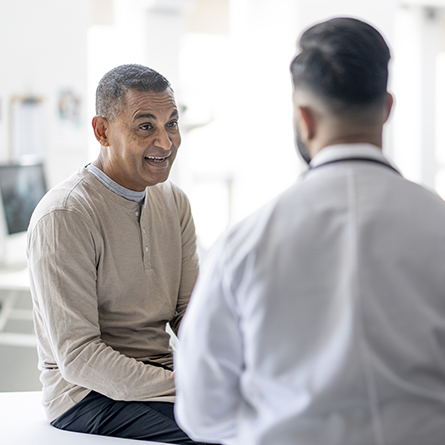 Male patient and doctor talking together