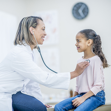 Doctor checking a child with a stethoscope