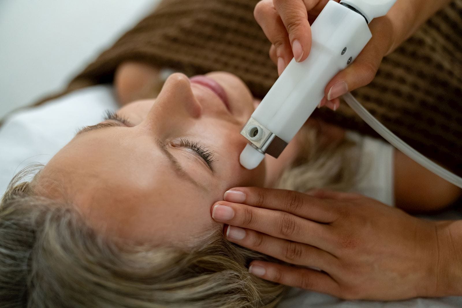 woman getting laser treatment on her face