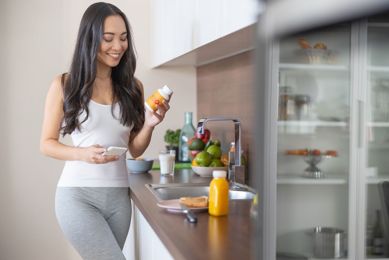 woman holding a medication bottle